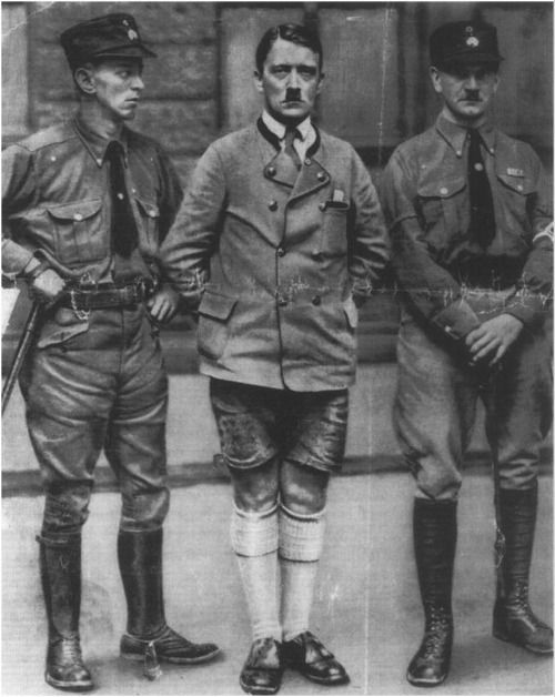 The Schutzstaffel (SS) is officially founded to serve for Hitler's personal protection. Hitler poses with Julius Schaub and Julius Shreck